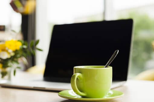 Laptop checkout workspace with coffee cup